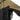 Two-tone rain shell jacket with olive upper sleeve and black zippered pocket