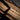 Tactical defender pen driving into wood, gun metal pointed tip