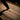 Tactical defender pen pressed into wooden board, gun metal pointed tip