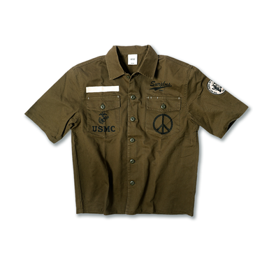 Olive drab utility overshirt with button front, two chest pockets, and graphic patches.