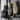 Three tactical one-strap assault packs hanging, black, olive green, and tan