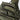 Olive green tactical one-strap assault pack close-up of front zipper and loops