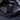 Black fabric pocket inside a gray backpack with stitched strap tab