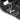 Black barefoot activity shoe close-up with metal lace clip and green MINVIL logo