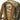 Camouflage backpack close-up with MILES label, front organizer pocket, and MOLLE webbing