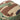 Camouflage boonie hat with green trim and fabric snap buttons