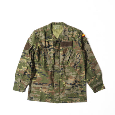 Camouflage combat field shirt with button front, chest flap pockets, and flag patch on shoulder