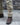 Desert camo combat pants hem with lace-up boot, close-up lower leg