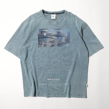 Light blue graphic crewneck T-shirt with rectangular blue print and "NAVAL FLEET" text