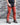 Orange-red and black panel pants with cargo pockets and a relaxed tapered leg fit