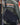 Navy side messenger bag worn across chest, with web strap and front flap pocket