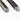 Close-up of tactical glassbreaker pen ends with metal caps and striker slots