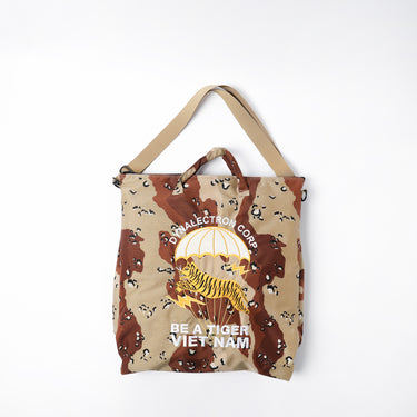 Desert camo helmet bag with tiger logo, top handles, and carry strap