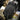 Black impact work glove with textured knuckle protector and molded palm tread.