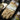 Tan impact work gloves on retail packaging with molded palm pads and wrist strap.
