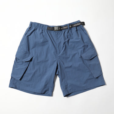 Blue vintage-style PCS shorts with cargo pockets and elastic waistband, black logo belt