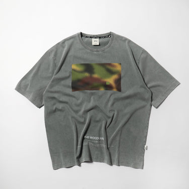 Grey crewneck tee with rectangular woodland graphic and small logo text near hem