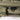 Olive rifle bag zipper pull with two-tone hardware and stitched seam