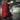 Carmine red 25L recurve takedown backpack worn on back with external attachment points