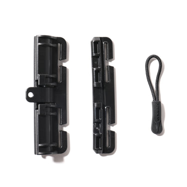 Black quick-release buckle with dual slots and attached loop cord.