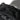 Black chest bag close-up of top fabric panel and small round emblem