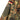 Camouflage field shirt sleeve with multi-color stripe armband and buttoned cuff.