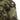 Woodland camo field shirt shoulder with rectangular flag patch and buttoned collar.