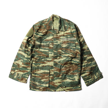 Camouflage field jacket with button front, flap chest pockets, and stand collar