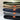 Stack of fleece watch caps in olive, coyote, midnight blue, and wolf grey