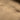 Close-up of tan fleece watch cap seam and stitched edge