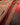 Jacket zipper close-up with metal pull and red-lined interior panels.