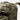 Helikon Ambush field backpack in woodland camouflage, with webbing loops and padded shoulder straps