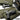 Olive-green bag interior with zip pockets holding handguns and firearm accessories