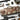 Urban camo rifle bag with top handle loops, front straps, and zippered storage sections