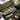 Open Multicam single rifle case interior with padded partitions and elastic storage loops.