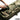 Multicam single rifle case close-up, top flap and adjustable strap over padded padding.