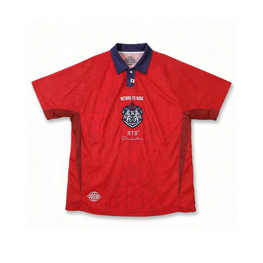 Red jersey shirt with navy collar and cuffs, embroidered chest crest logo, short sleeves