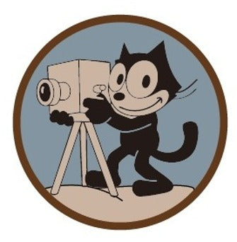 Round fabric patch with Felix the Cat character on a film camera tripod