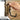 Tan adjustable J-hook mounted to slat wall with hand tightening swivel lock