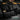 Black double rifle case with large outer pocket panels and looped strap details