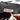 Utility pouch close-up with black label patch and hand holding a red marker