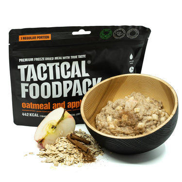 Black freeze-dried meal pouch with oatmeal and apples, wooden bowl and dried flakes