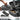 Gray soft loose sac ammo carrier with open top, webbing handle, and front label patch