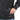 Black fleece jacket with zip hand pocket and logo patch near the hem