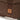 Brown chest pack with stitched flap and square tan patch on webbing
