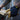 Abrasion-resistant work gloves on hand, tan palm and black back with MechaniX print