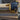 Abrasion-resistant work gloves, black cuff with yellow tag and tan palm with MechaniX print