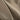Solid tan tactical shirt fabric close-up with fine woven texture