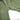 Green compression pants fabric and curved seam detail near leg opening