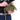 Olive mini travel pouch held in hand, with logo patch and zip pocket